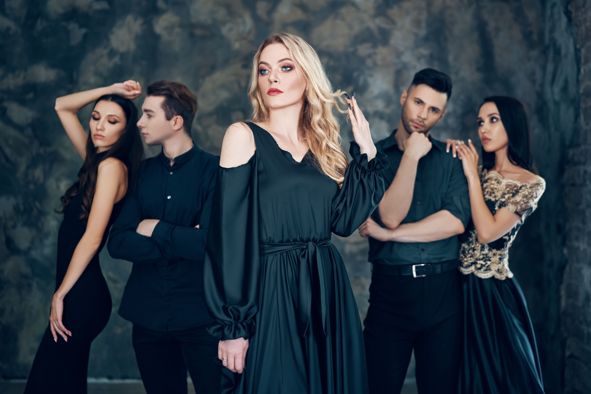Group of young beautiful people posing in studio